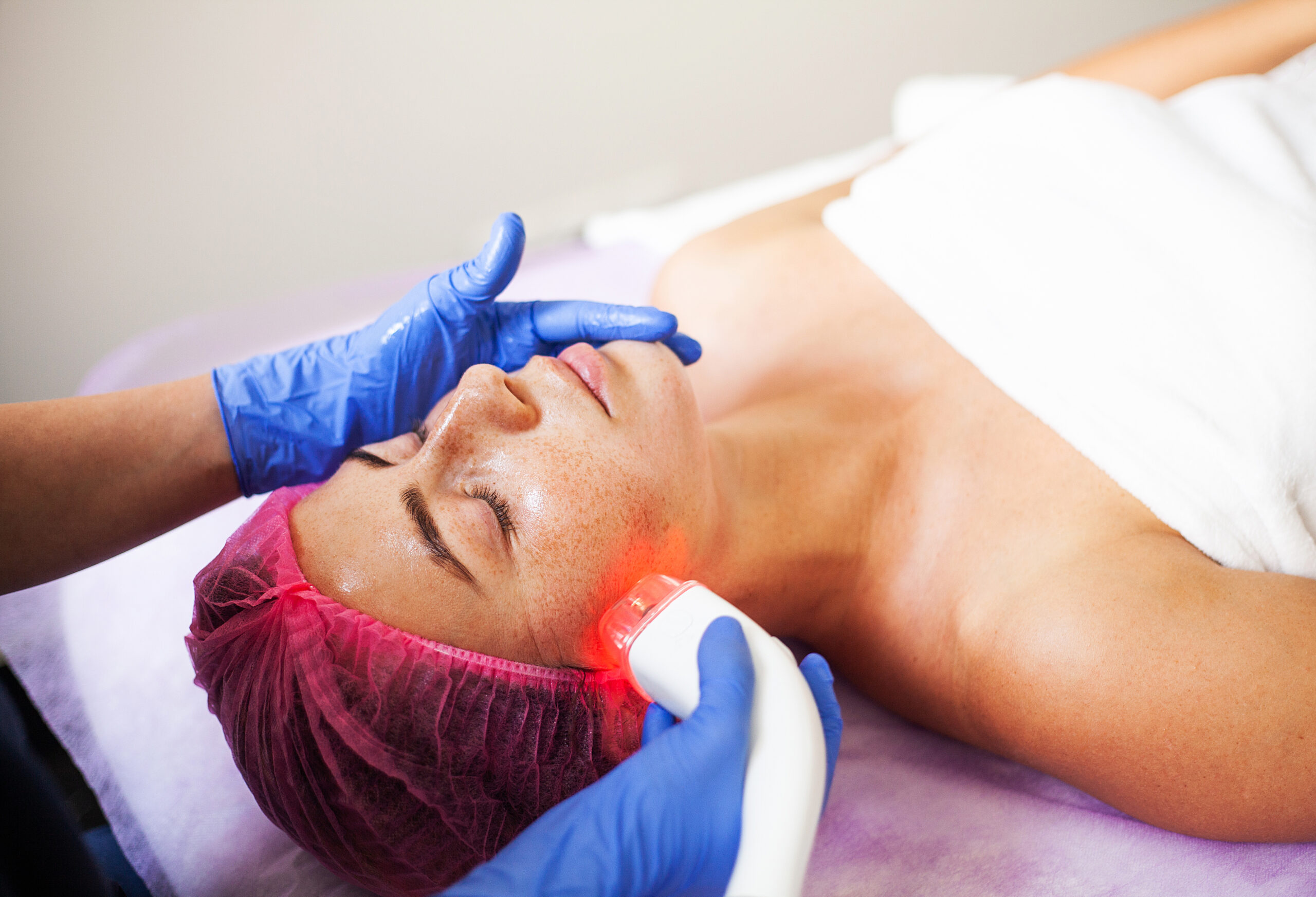Woman getting LPG hardware massage at the beauty clinic. Professional beautician working.